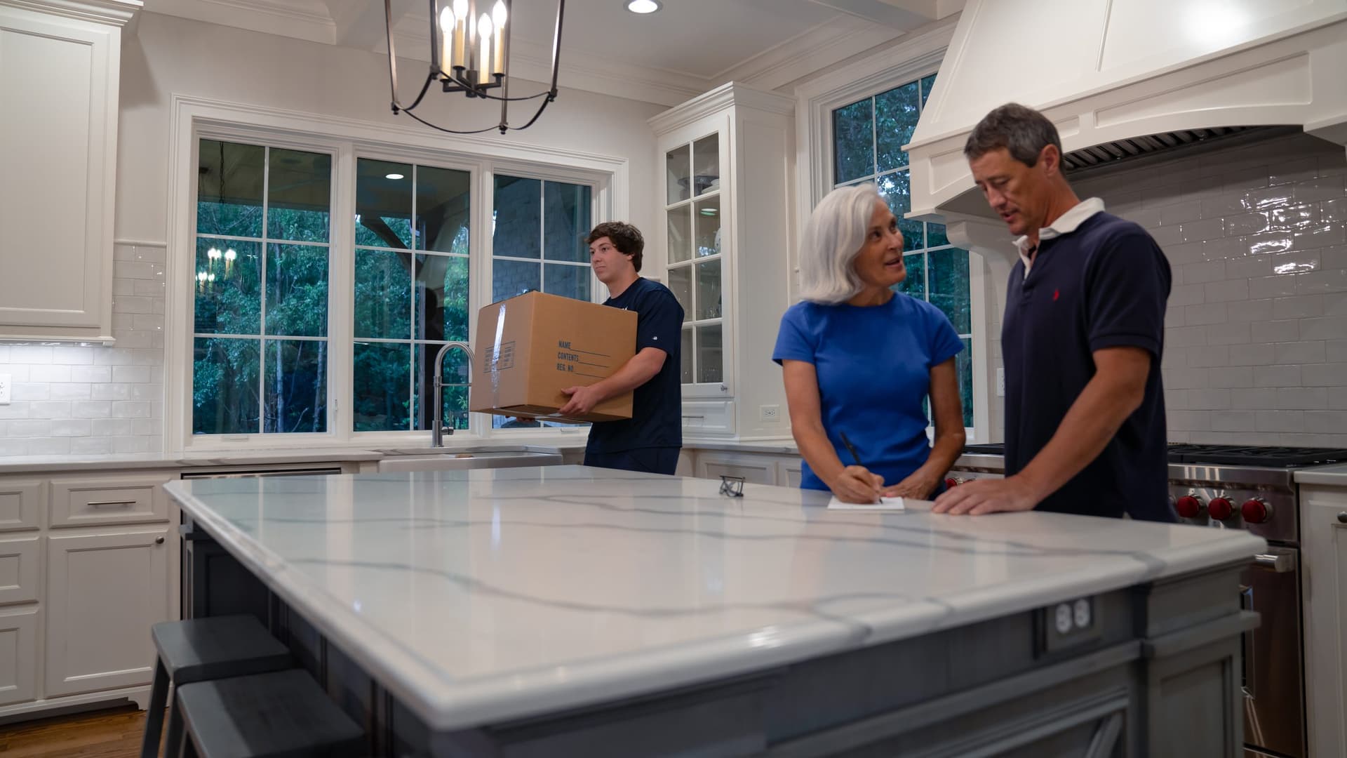 Undergrads crew member with happy customers reviewing move details